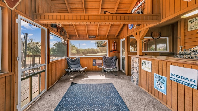 sunroom featuring vaulted ceiling with beams and wood ceiling