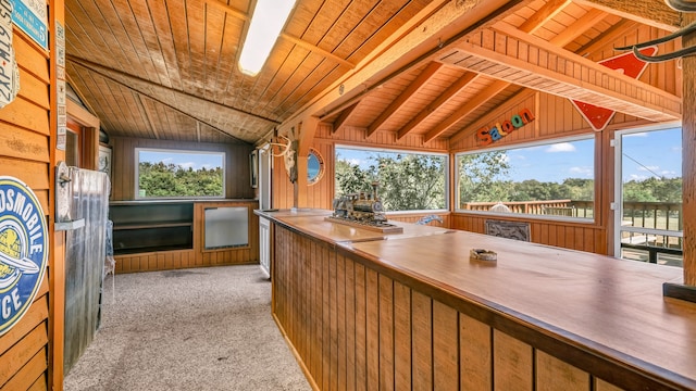 sunroom / solarium featuring wood ceiling and lofted ceiling with beams