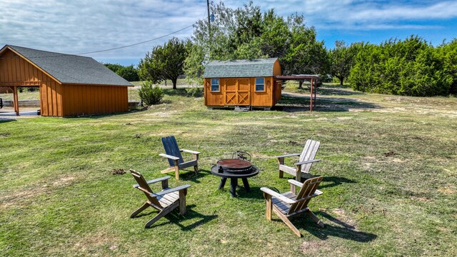 view of yard with a storage unit and a fire pit