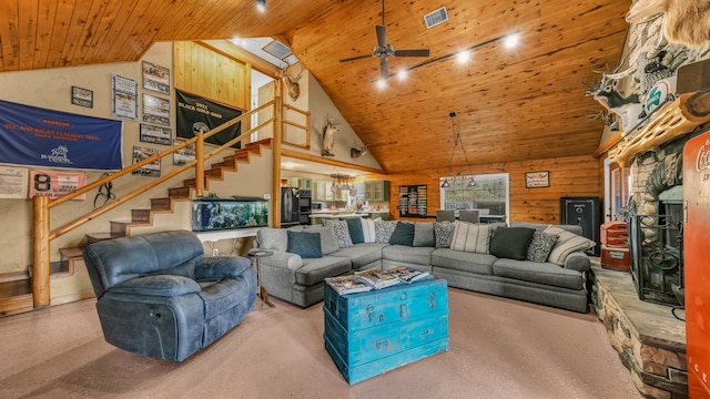 living room with wood walls, high vaulted ceiling, wooden ceiling, and ceiling fan with notable chandelier