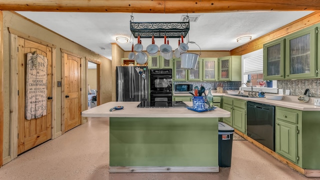 kitchen with decorative backsplash, green cabinets, sink, black appliances, and a center island