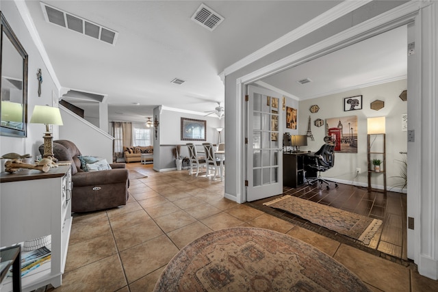 living room with tile patterned floors, crown molding, and ceiling fan