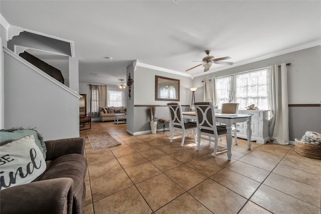 interior space featuring ceiling fan, a healthy amount of sunlight, and ornamental molding