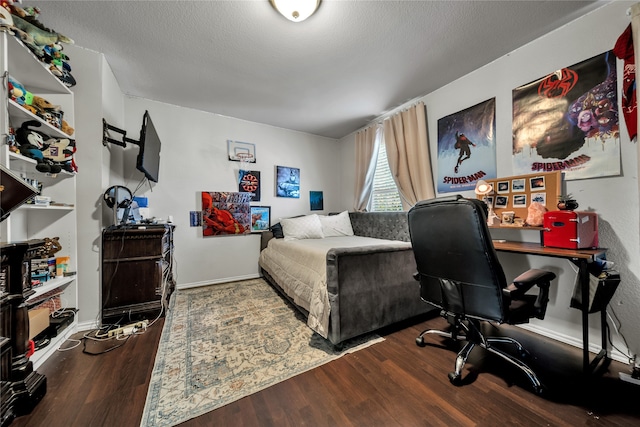 bedroom featuring a textured ceiling and hardwood / wood-style floors