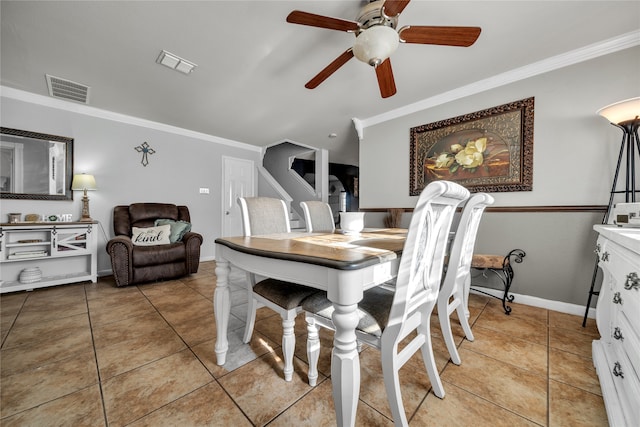 dining room featuring ceiling fan, ornamental molding, and light tile patterned flooring