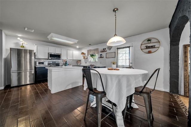 dining room with dark hardwood / wood-style floors