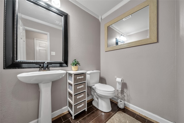 bathroom featuring toilet, crown molding, and hardwood / wood-style floors