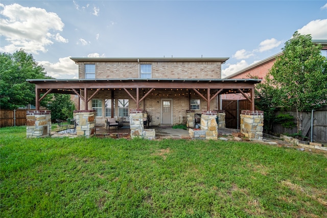 rear view of house with a patio area and a lawn