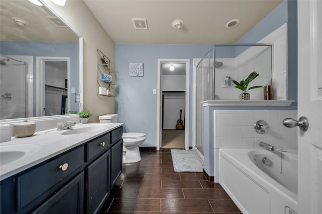 full bathroom featuring vanity, shower with separate bathtub, and toilet