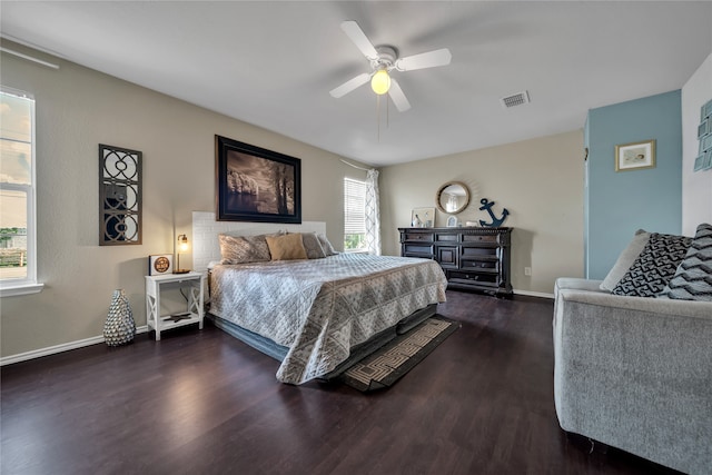 bedroom with dark hardwood / wood-style floors and ceiling fan