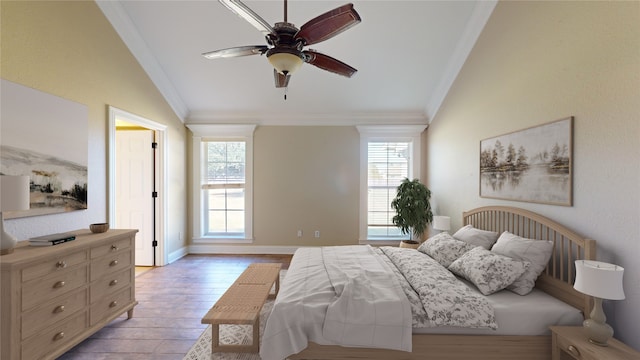 bedroom with ornamental molding, vaulted ceiling, light wood-type flooring, and ceiling fan