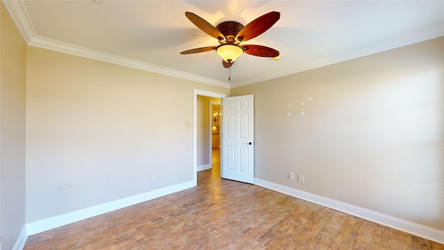 empty room with ornamental molding, wood-type flooring, and ceiling fan