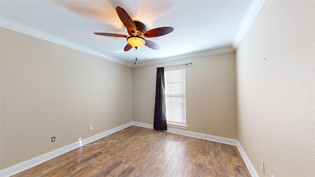 empty room featuring crown molding, hardwood / wood-style flooring, and ceiling fan