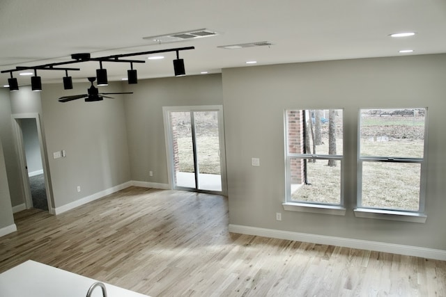 unfurnished room featuring light hardwood / wood-style floors and ceiling fan