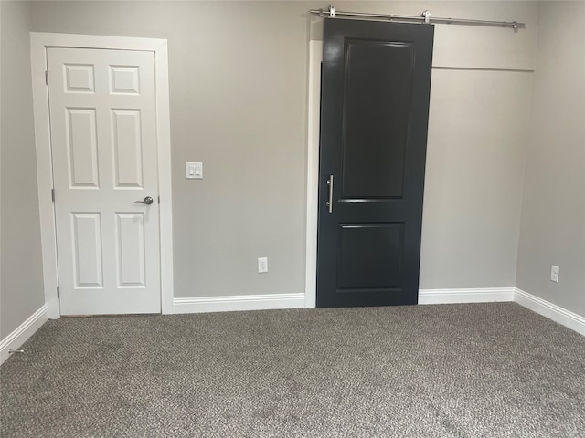 unfurnished bedroom with dark colored carpet