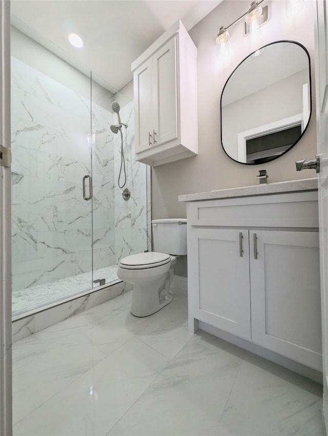 bathroom with a shower with door, vanity, and toilet