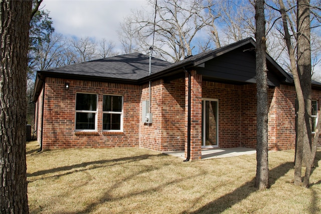 rear view of property featuring a yard, central air condition unit, and a patio