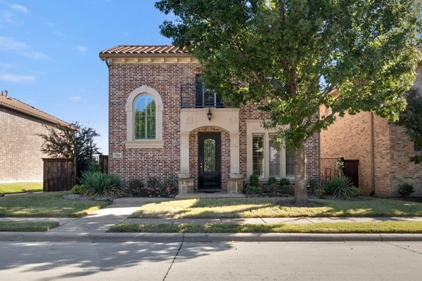 mediterranean / spanish-style home with a front lawn