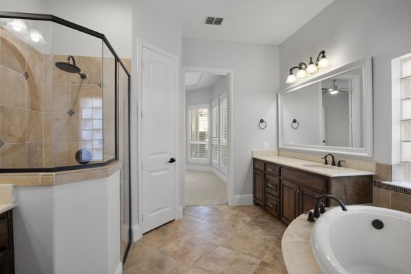 bathroom featuring vanity and plus walk in shower