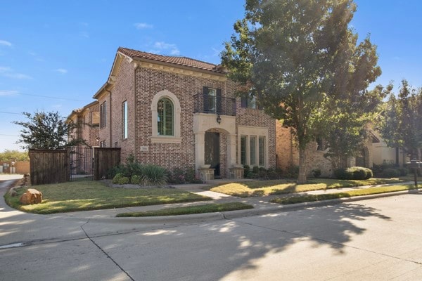 mediterranean / spanish-style home featuring a front lawn