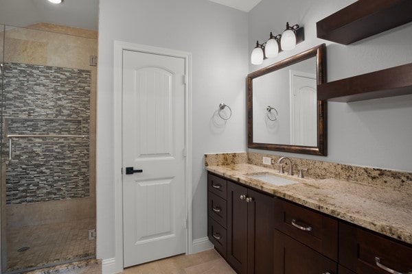 bathroom featuring vanity, tile patterned flooring, and walk in shower