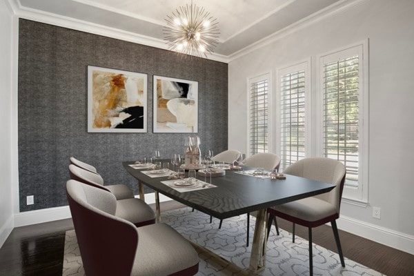 dining space with a notable chandelier, hardwood / wood-style floors, and crown molding