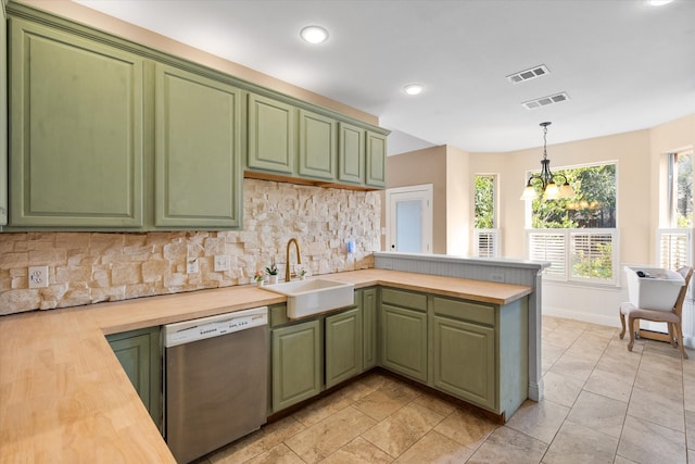 kitchen with kitchen peninsula, hanging light fixtures, wood counters, stainless steel dishwasher, and sink