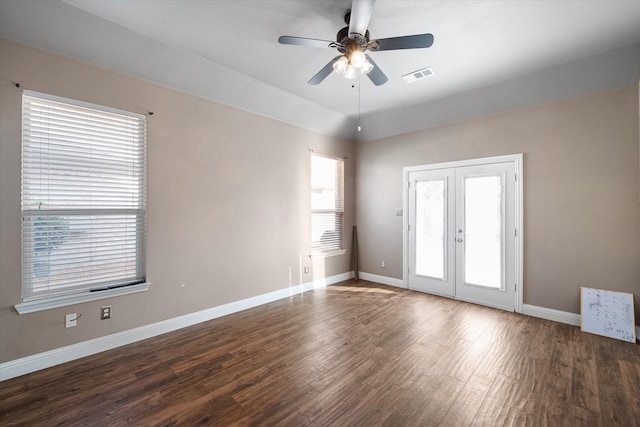 unfurnished room featuring dark hardwood / wood-style flooring, french doors, ceiling fan, and a wealth of natural light