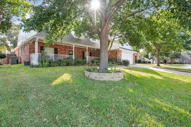 view of front of house with central air condition unit, covered porch, a front yard, and a garage