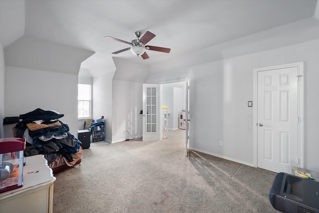 misc room featuring french doors, ceiling fan, carpet, and vaulted ceiling