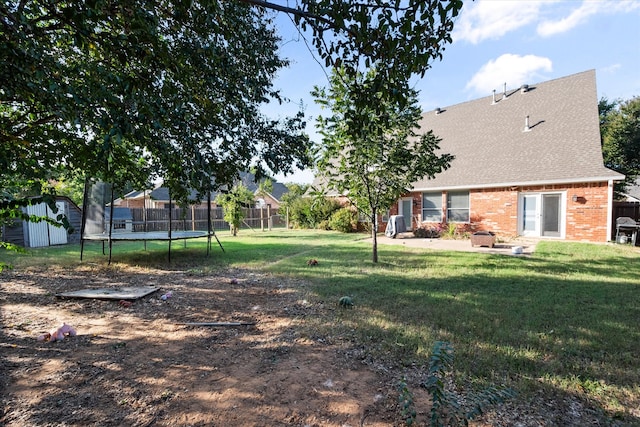 view of yard with a patio area, a shed, and a trampoline