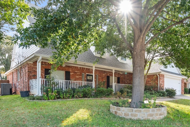 view of front facade featuring central air condition unit, a front lawn, covered porch, and a garage