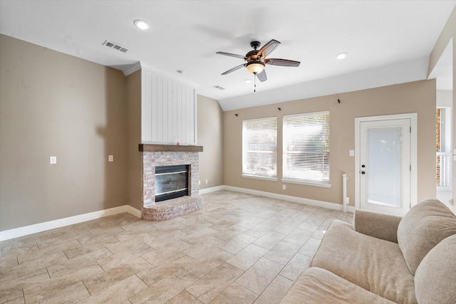 living room featuring ceiling fan and a brick fireplace