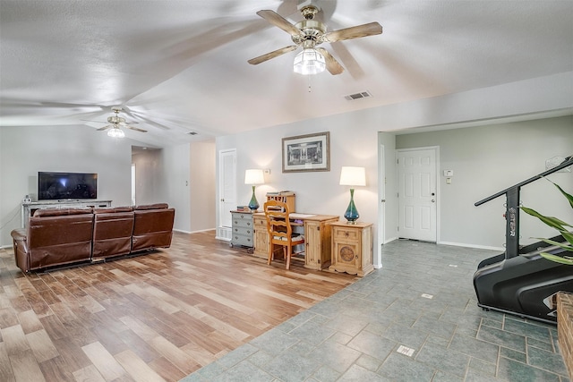 living room with a textured ceiling, hardwood / wood-style flooring, and vaulted ceiling