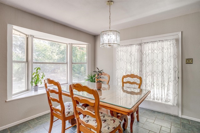 dining room with a healthy amount of sunlight and an inviting chandelier