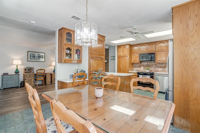 dining area with ceiling fan with notable chandelier and dark wood-type flooring