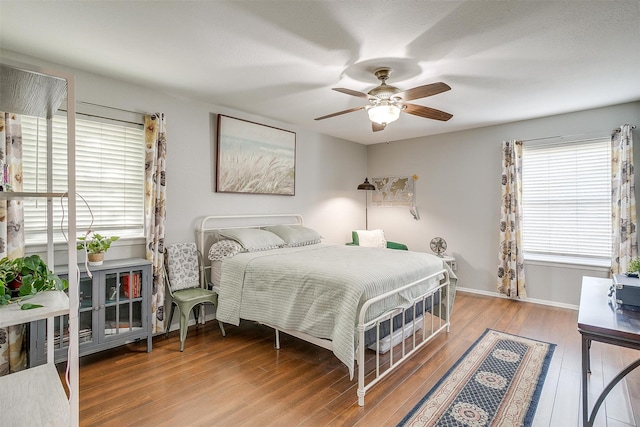 bedroom with wood-type flooring and ceiling fan