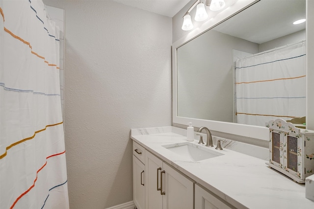 bathroom with a shower with curtain and vanity