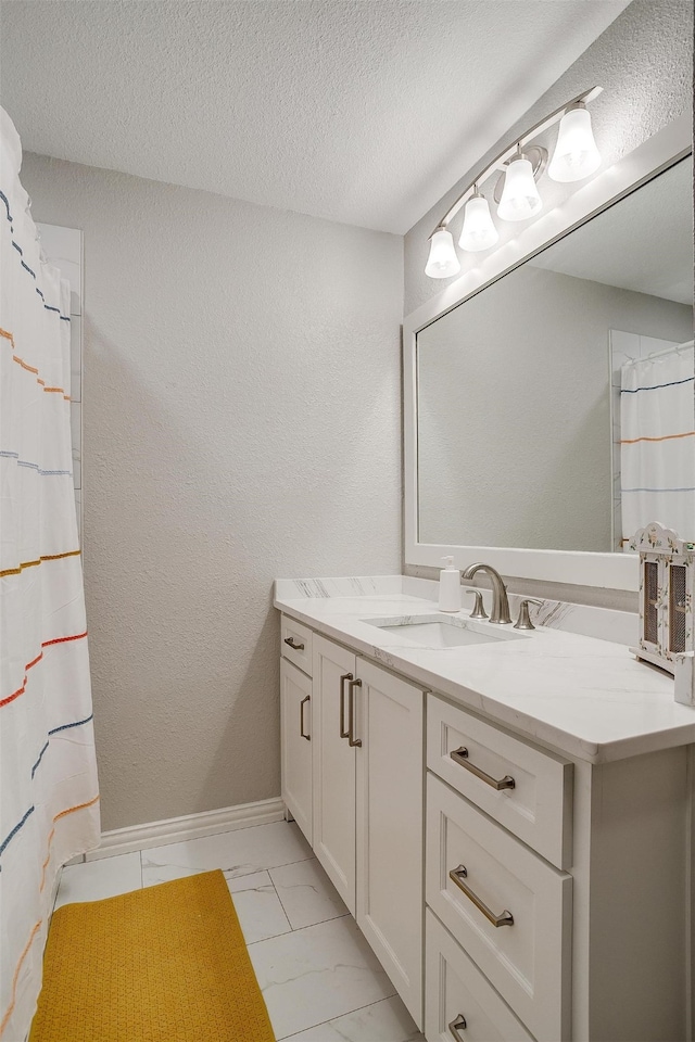 bathroom with vanity and a textured ceiling