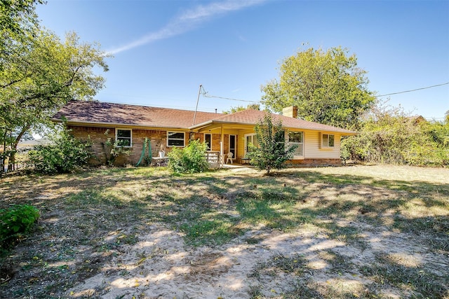 rear view of house with a yard