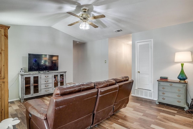 living room featuring light hardwood / wood-style floors, ceiling fan, and lofted ceiling