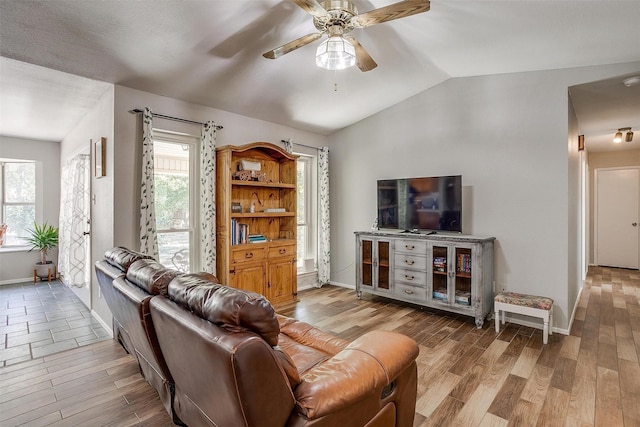 living room featuring lofted ceiling, ceiling fan, and wood-type flooring