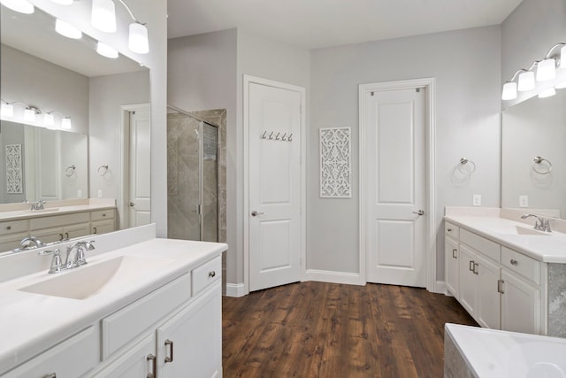 bathroom with vanity, wood-type flooring, and an enclosed shower