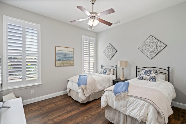 bedroom with ceiling fan and dark hardwood / wood-style floors