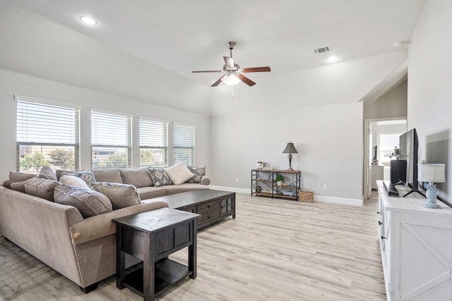 living room featuring light hardwood / wood-style flooring, high vaulted ceiling, and ceiling fan