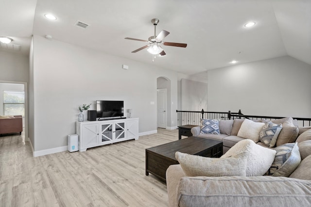 living room featuring lofted ceiling, light wood-type flooring, and ceiling fan