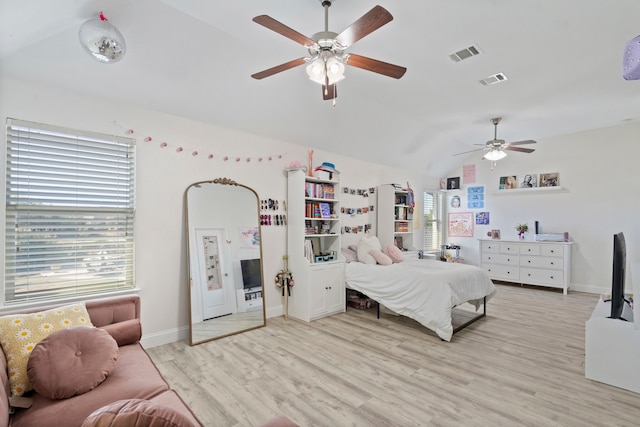 bedroom with vaulted ceiling, light hardwood / wood-style flooring, and ceiling fan