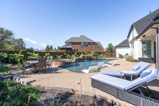 view of swimming pool featuring an in ground hot tub, pool water feature, and a patio