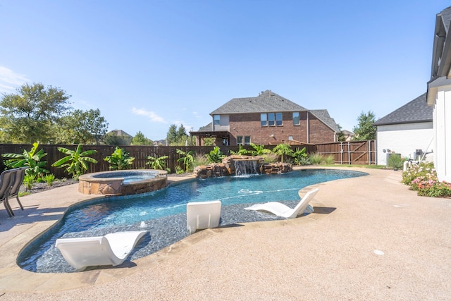 view of swimming pool featuring a patio, pool water feature, and an in ground hot tub