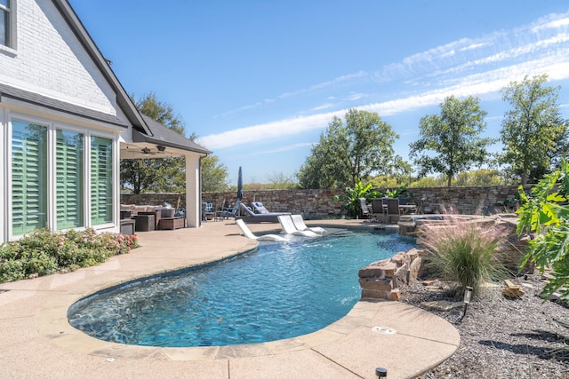 view of swimming pool featuring an outdoor living space, a patio area, and ceiling fan